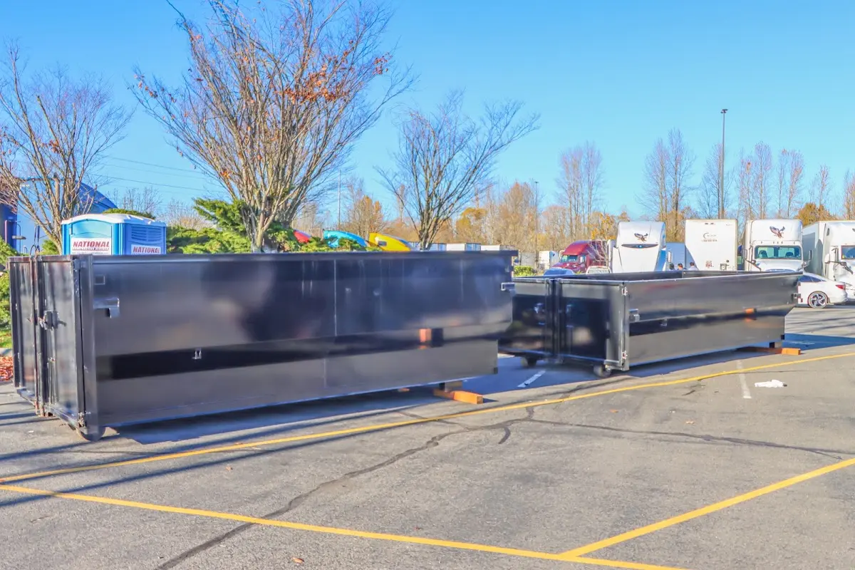 Professional dumpster rental service with roll-off container on residential driveway in Picture Rocks